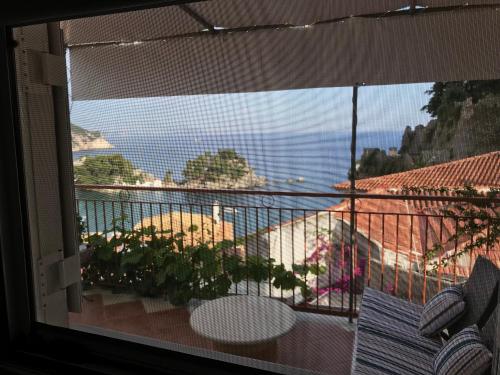 a balcony with a table and a view of the ocean at Marthas Studios in Parga