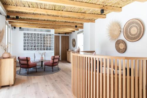 
a room with a wooden floor and a wooden ceiling at Adorno Beach Hotel and Suites in Ornos
