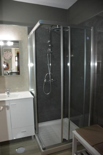 a shower with a glass door in a bathroom at Porto Santo Apartment in Porto Santo