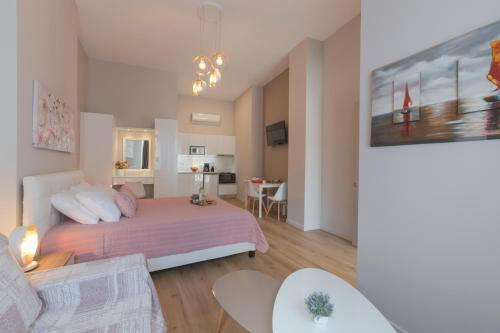 a bedroom with a bed and a living room at Saint George unique studio in Nafplio