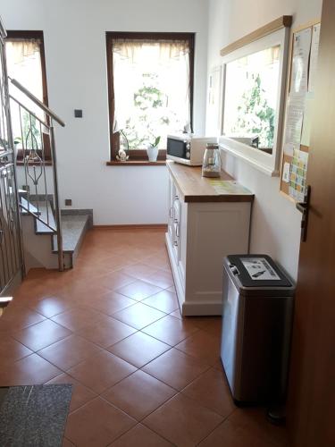a kitchen with a counter and a trash can at Villa Kapitańska in Kołobrzeg