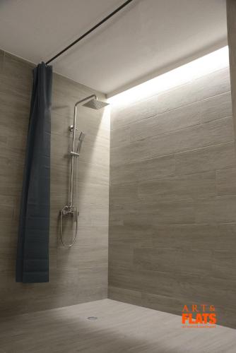a shower with a shower head in a bathroom at Art&Flats Hostel in Valencia