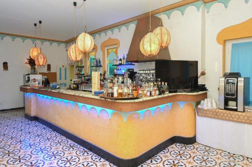 a bar in a hotel room with a counter at Hotel Arabesque in Varigotti