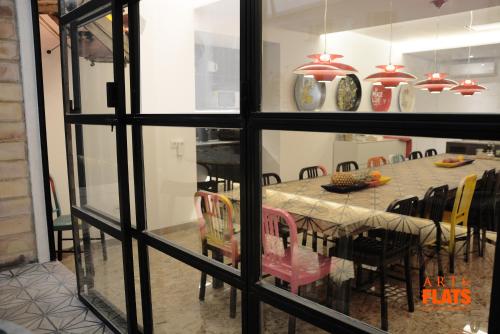 a dining room with a table and chairs through a window at Art&Flats Hostel in Valencia