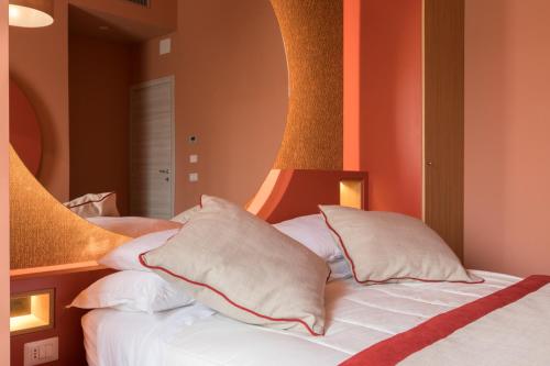 a bedroom with a bed with white pillows at Le Texture Premium Rooms Duomo-Cordusio in Milan