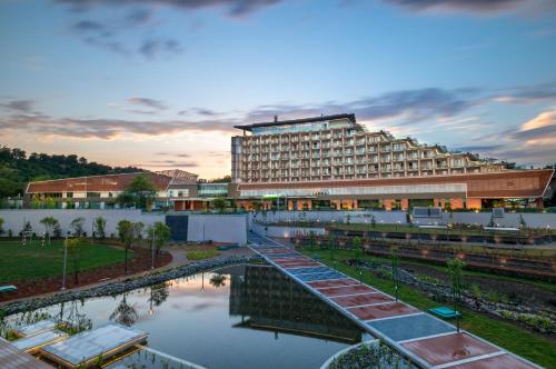 a large building with a river in front of it at Lankaran Springs Wellness Resort in Lankaran