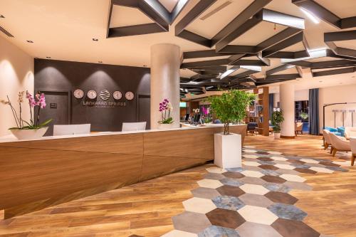 an office lobby with a reception counter and flowers at Lankaran Springs Wellness Resort in Lankaran