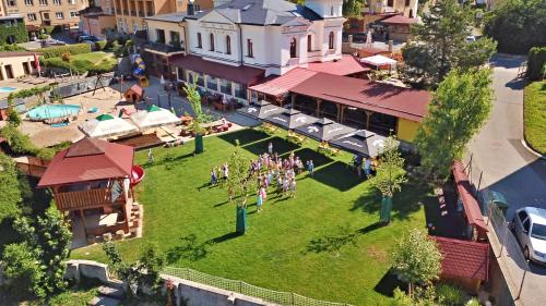 a group of people standing on a lawn in front of a building at Penzion Bejby Turnov in Turnov