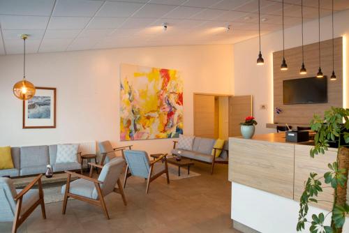 a waiting room in a hospital with chairs and a table at Hotel Gullfoss in Haukadalur