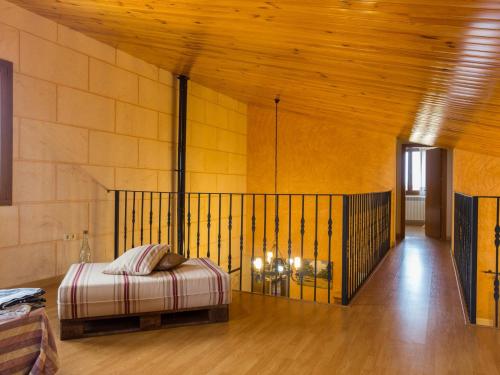 a bedroom with a bed and a wooden ceiling at Es rafalot in Binissalem