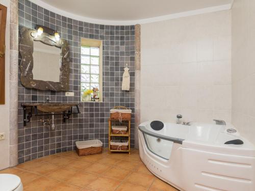 a bathroom with a tub and a sink at Es rafalot in Binissalem