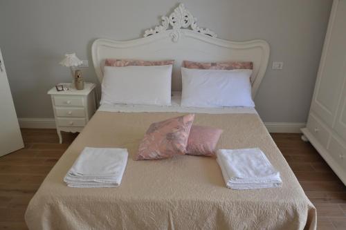 a bedroom with a bed with two pillows on it at B&B Coffee and City Pompei in Pompei