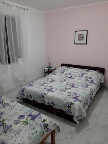 a bedroom with two beds and a window at Apartments Juretic in Drenje