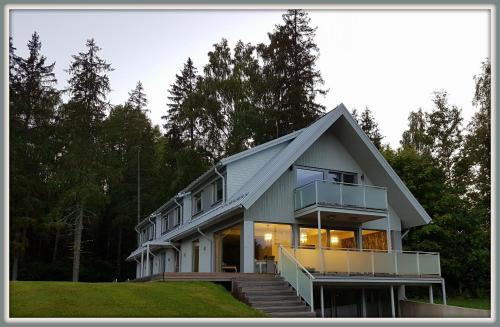a large white house with a gambrel roof at William Willa in Otepää