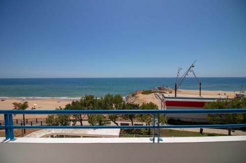 a view of the beach from the balcony of a condo at Quarteira Beach in Quarteira
