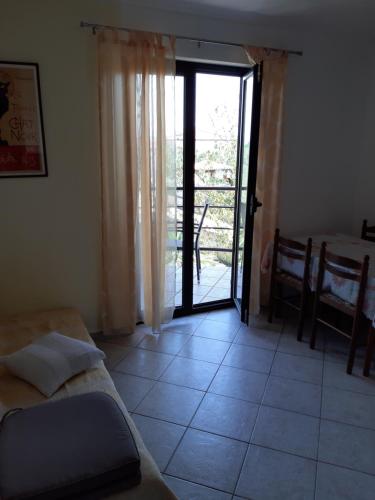 a living room with a door open to a patio at Apartments Juretic in Drenje