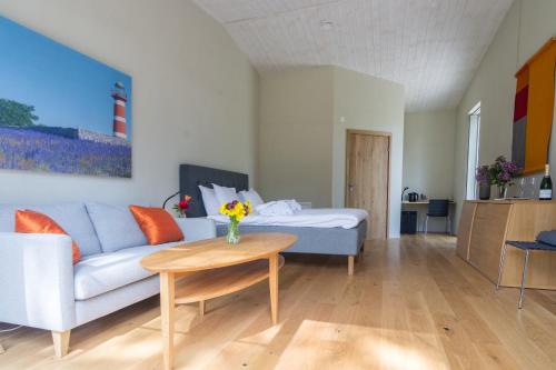 a living room with a couch and a table at Strandakar Hotell & Restaurang in Stånga