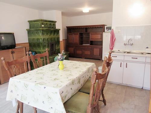 a kitchen with a table with a white table cloth at 2+2 fős apartman Badacsonytomaj központjában in Badacsonytomaj
