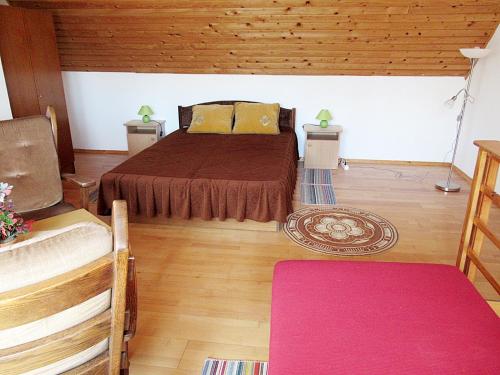 a bedroom with a large bed and wooden floors at 2+2 fős apartman Badacsonytomaj központjában in Badacsonytomaj