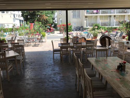 an empty restaurant with tables and chairs in a courtyard at Oleander House and Tennis Club in Sunny Beach