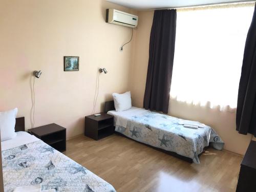 a room with two beds and a window at МОТЕЛ СИТИ in Plovdiv