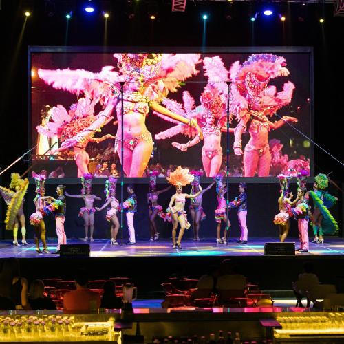 a group of dancers performing on a stage at Titanic Mardan Palace in Lara