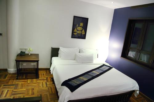 Postel nebo postele na pokoji v ubytování Indigo House Hotel