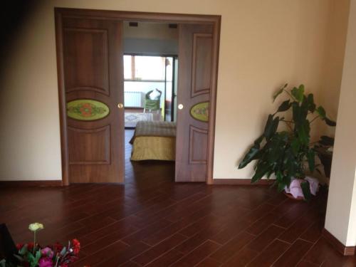 a living room with two doors and a plant at Magnolia House in Taurianova
