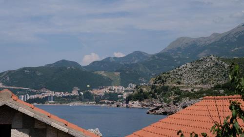 a view of a body of water with mountains at Kazanegra Exclusive Apartments in Sveti Stefan