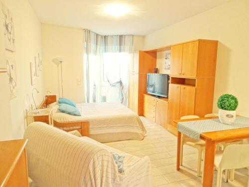 a hotel room with a bed and a tv at Casa Vacanze Stelle Marine in Santo Stefano al Mare