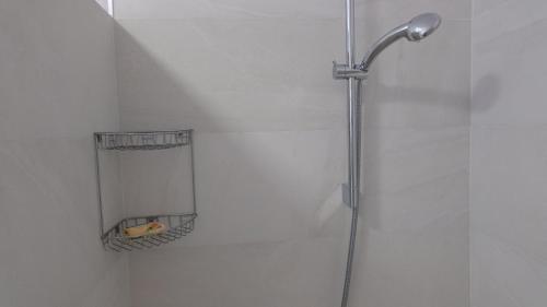 a shower with a mirror in a bathroom at Kazanegra Exclusive Apartments in Sveti Stefan