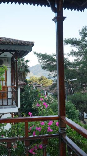 a balcony of a house with pink flowers at Totelya Hotel in Akyaka