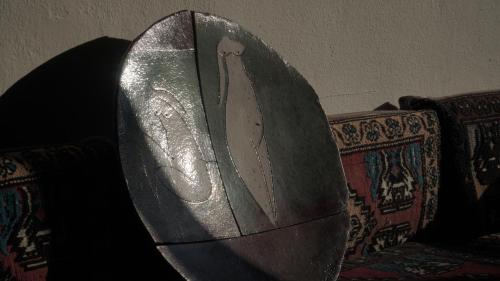 a shield sitting on top of a couch at Totelya Hotel in Akyaka