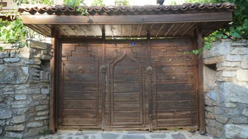 a wooden garage door in a stone wall at Totelya Hotel in Akyaka