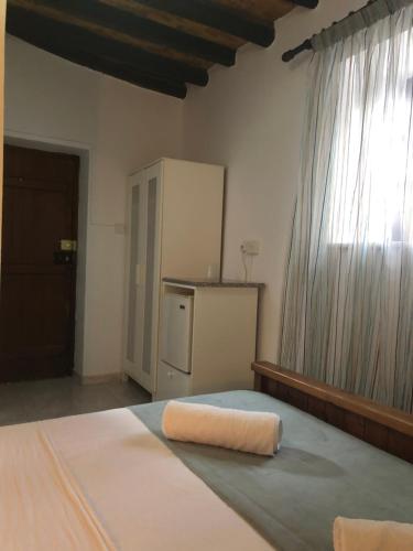 Ένα ή περισσότερα κρεβάτια σε δωμάτιο στο Villa Thermopilon