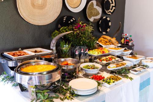 a buffet with many dishes of food on a table at Inyati Game Lodge in Sabi Sand Game Reserve