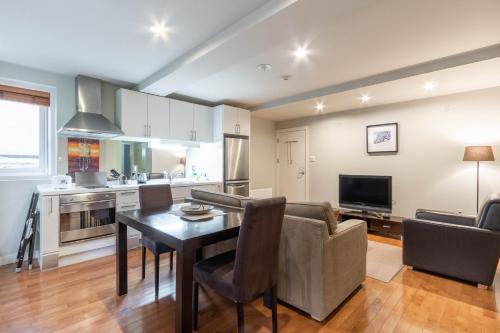 a kitchen and living room with a couch and a table at Fresh Powder Accommodation in Furano