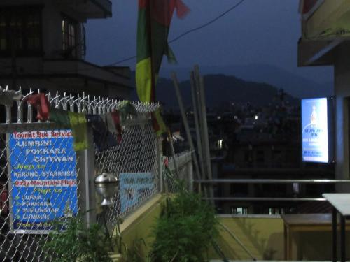 a fence with a sign on top of a building at STUPA VIEW INN in Kathmandu