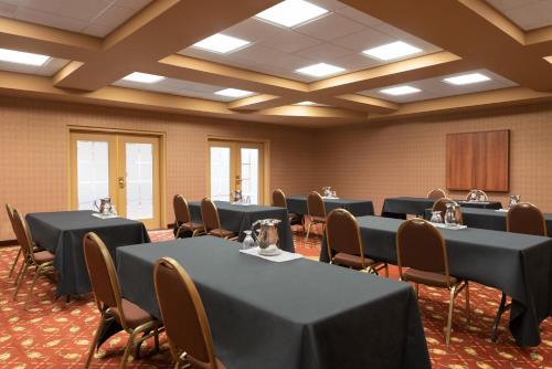 a conference room with tables and chairs and a podium at Days Inn by Wyndham Swift Current in Swift Current