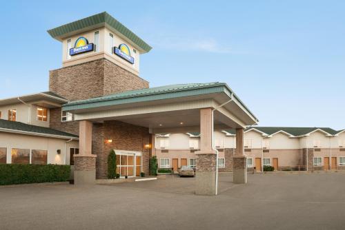a building with a clock tower on top of it at Days Inn by Wyndham Swift Current in Swift Current