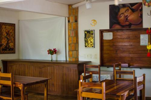 a dining room with a table and a table and chairs at Pousada Morada do Sol in Canoa Quebrada