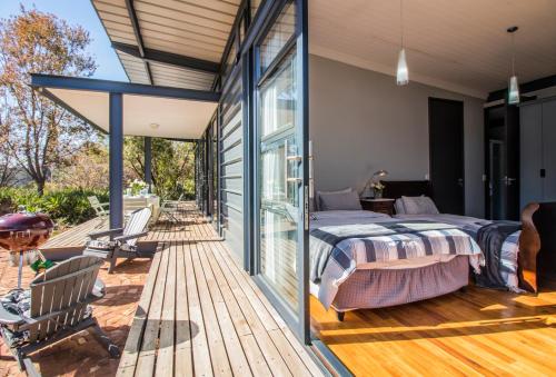 a master bedroom with a bed on a wooden deck at Wolf Unit in Pretoria