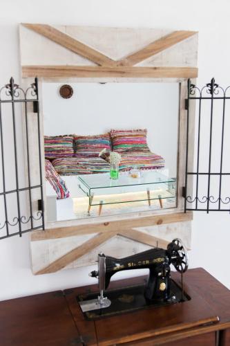 a mirror above a sewing machine on a table at Gorgona Traditional Studio in Karpathos Town