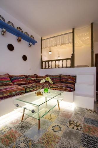 a living room with a couch and a glass table at Gorgona Traditional Studio in Karpathos Town