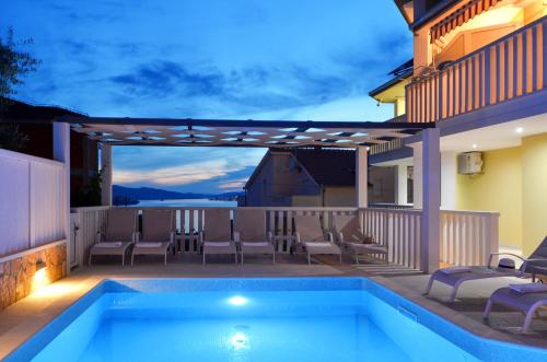 a swimming pool on the balcony of a house at Apartments Tomislav in Trogir