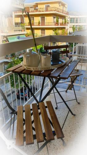 a table with pots and pans on top of a balcony at Socrates path in Athens