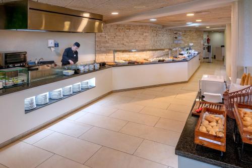 
a kitchen filled with lots of counter space at GHT S'Agaró Mar Hotel in Sant Feliu de Guíxols
