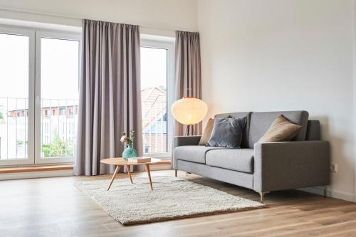 a living room with a couch and a table at Boardinghome Oldenburg in Oldenburg