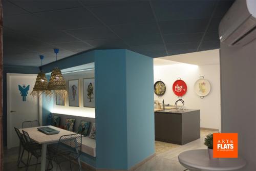 a room with a table and a dining room with clocks at Art&Flats Hostel in Valencia
