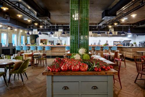 a table with vegetables on it in a restaurant at Max Brown Hotel 7th District, part of Sircle Collection in Vienna